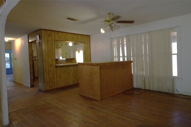 Living area looking into the kitchen.  Sunroom is