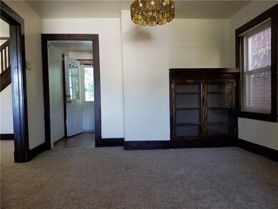 Dining room view into living room and kitchen. Kit