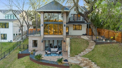 Back of house featuring a patio, metal roof, stai