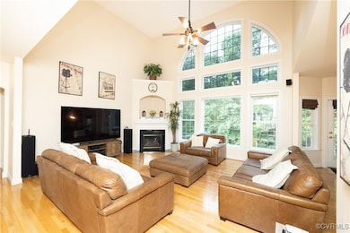 Living area featuring high vaulted ceiling, light
