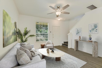 Living room featuring stairs, wood finished floor