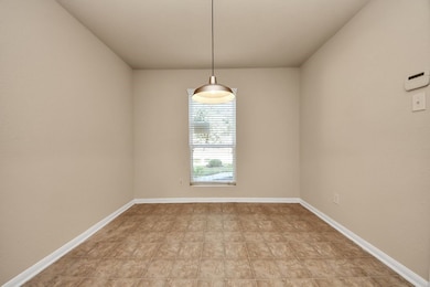 A den that can also be utilized as a formal dining room or breakfast nook positioned adjacent to the kitchen.