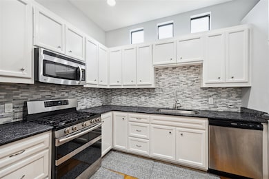 There is an abundance of white kitchen cabinets
