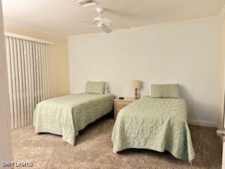 Carpeted bedroom with crown molding and a ceiling