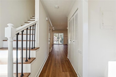 Corridor with electric panel, baseboards, wood fin