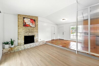 Unfurnished living room with lofted ceiling, a st