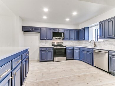 Kitchen featuring tasteful backsplash, light wood-