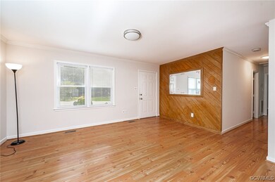 Living room with view of front entry to home and h