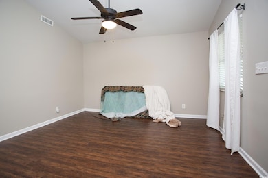 Spare room with dark hardwood / wood-style floorin