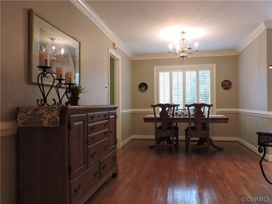 Dining Room with crown and chair molding, wood flo