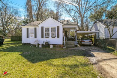 View of front of home with a front lawn and a carp