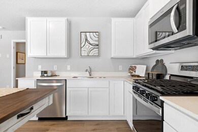 Stainless steel appliances and quartz countertops. Photo is of model home. Colors and options may vary. Ask Sales Agent for details.