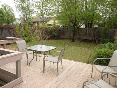 Trees, deck and privacy fenced yard.
