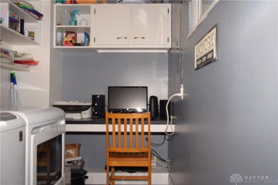 Laundry with a computer station and door to back p