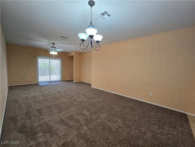 Spare room featuring carpet floors, a chandelier,