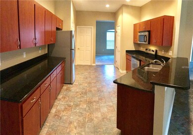 Spacious Kitchen With Stainless Appliances and Gra