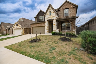 View of front of house featuring fence, stone sid