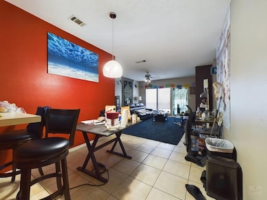 Dining room with light tile patterned floors, vis