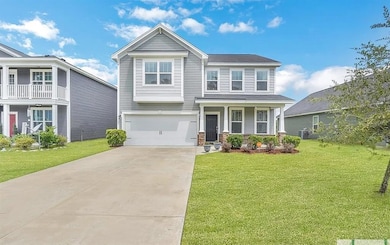 View of front of property with driveway, a front yard, an attached garage, central AC unit, and covered porch