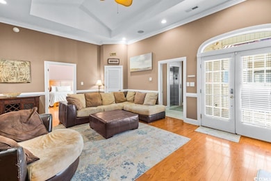 Living room featuring french doors, lofted ceiling