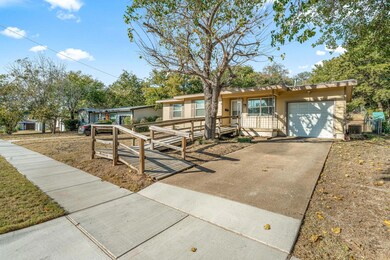 View of front of house featuring a garage and cool