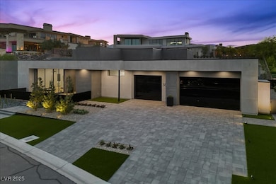 Modern home featuring decorative driveway and an a