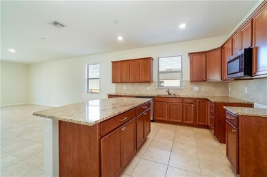 The kitchen is complete with a large island with b