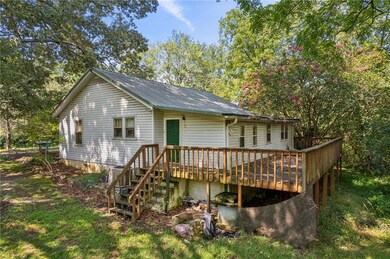 Back of house featuring a wooden deck
