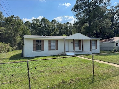View of front of property featuring brick siding and covered porch