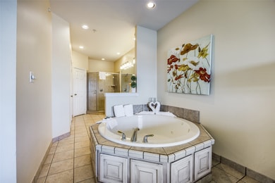 Bathroom with tile patterned flooring and plus walk in shower