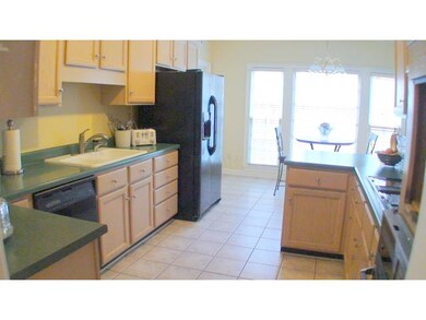 Kitchen has Tile floors. New refrigerator and an a