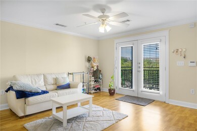 Living room with ornamental molding, wood finished