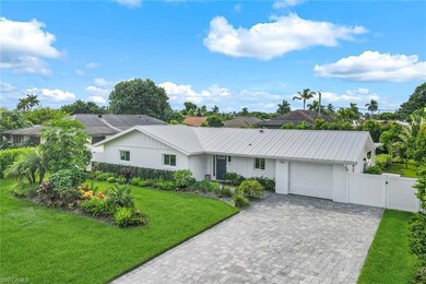 Single story home featuring a front lawn and a gar
