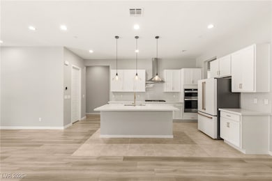 Kitchen featuring light countertops, tasteful back