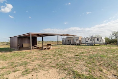 View of yard featuring an outbuilding and a carport