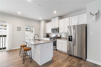 Large granite island with sink, dishwasher, storag
