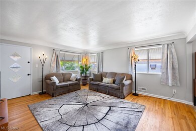 Living room with a textured ceiling and light wood-type flooring