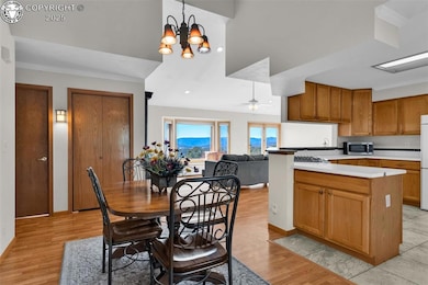 Dining room featuring ceiling fan, a chandelier, ornamental molding, light wood-style flooring, and recessed lighting