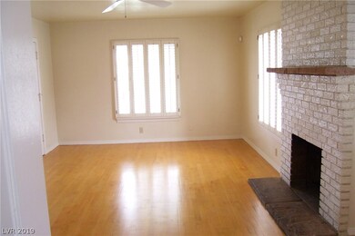 Living room with wood-burning fireplace.
