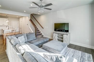 Living room with sink, dark wood-type flooring, an
