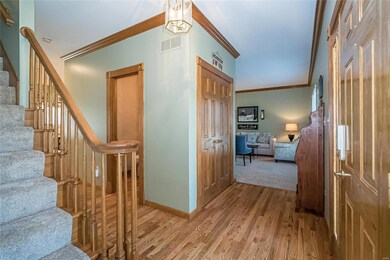 Entry foyer - wood floors, crown molding, stained 