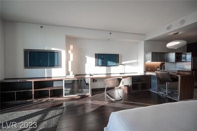 Living area with wood-type flooring and built in d