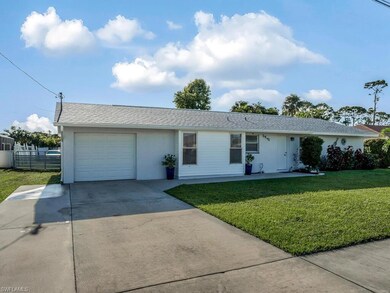 Oversized concrete driveway and garage with gate l