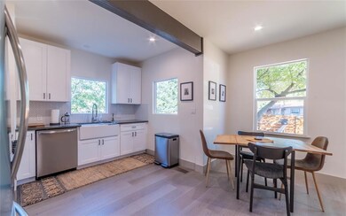 Kitchen with dark countertops, appliances with st