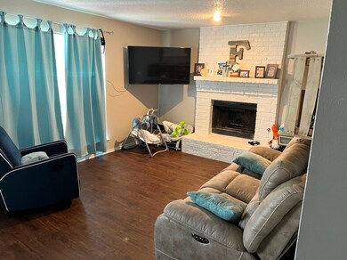 Living room featuring wood look floors and a fireplace