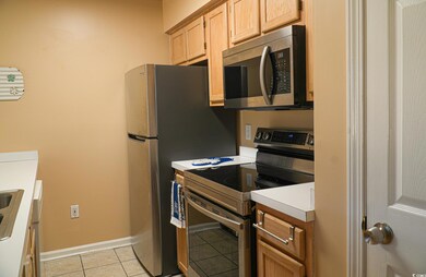 Kitchen featuring light brown cabinets, stainless 