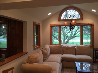 Sun filled family room with Cathedral ceiling.