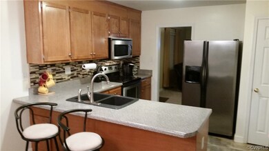 Kitchen with snack bar viewed from breakfast room