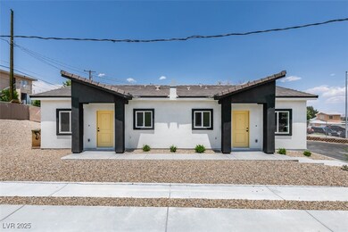View of front of home with stucco siding and a til