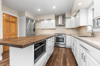 Kitchen with butcher block center island counterto